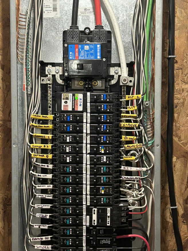 A newly installed and labeled electrical panel by KG Electric LLC in Cumberland, RI