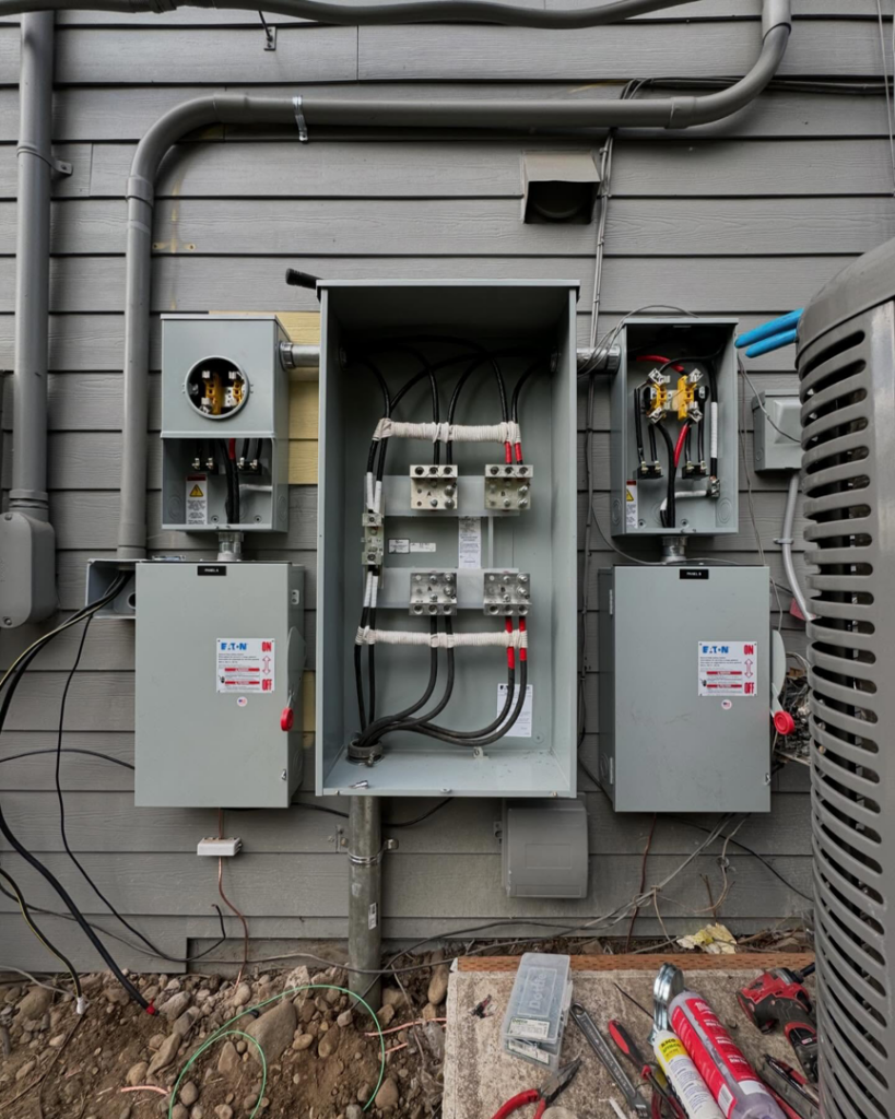 An ongoing electrical panel installation and wiring work on the exterior of a building by LN Electrical in Coeur D Alene, ID