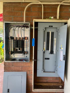 An open electrical panel installation with wiring and circuit breakers visible, performed by Mcdaniel Electric, LLC in Waipahu, HI.