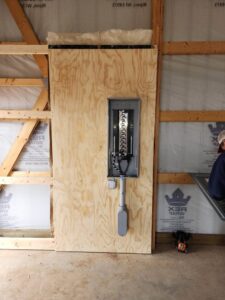 An electrical panel installed on a plywood backer in a new construction project by Apparent Electric LLC in Oshkosh, WI.