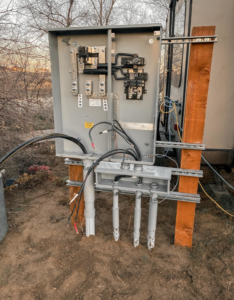 An open electrical panel with conduits and wiring being installed by Tier 1 Electric in Boise, ID.