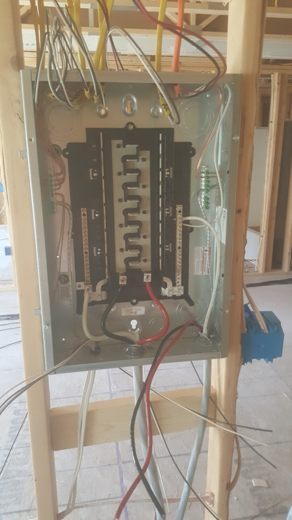 An electrical panel installation with wiring in a framed wall by 2 Phase Electric LLC in Barnesville, MN.