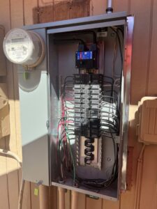 An open electrical panel with circuit breakers and wiring installed by G5 Electric LLC in Phoenix, AZ