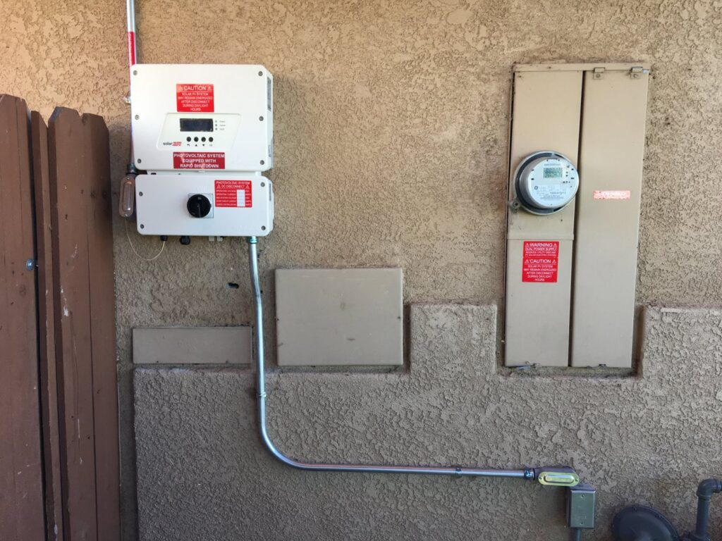 An exterior electrical panel and solar inverter installation by Solar & Electric Service Bros in West Sacramento, CA.