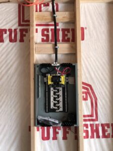 An electrical panel installed within a wooden stud frame during new construction by All 4 You Electrical in Boise, ID.