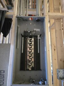 An electrical panel box and conduit installed during rough-in construction by ILIC Electric in Chicago, IL.