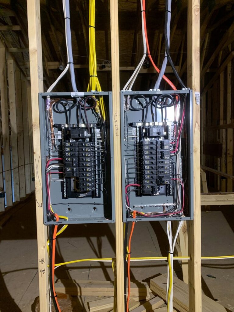 Two electrical panels with rough-in wiring installed in a new construction by Zimmerman Electric Indy in Indianapolis, IN