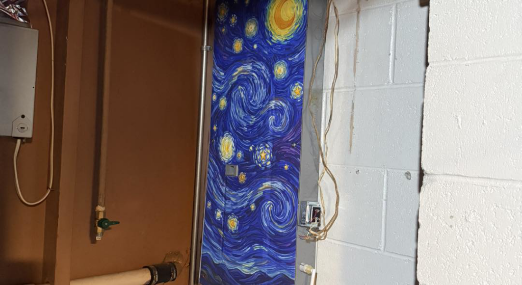 An electrical panel with a decorative Starry Night cover installed by Down The Road Electric Inc in Iowa City, IA