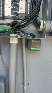 An open electrical panel with wiring and a surge protection device installed by PlugTech LLC in Orlando, FL