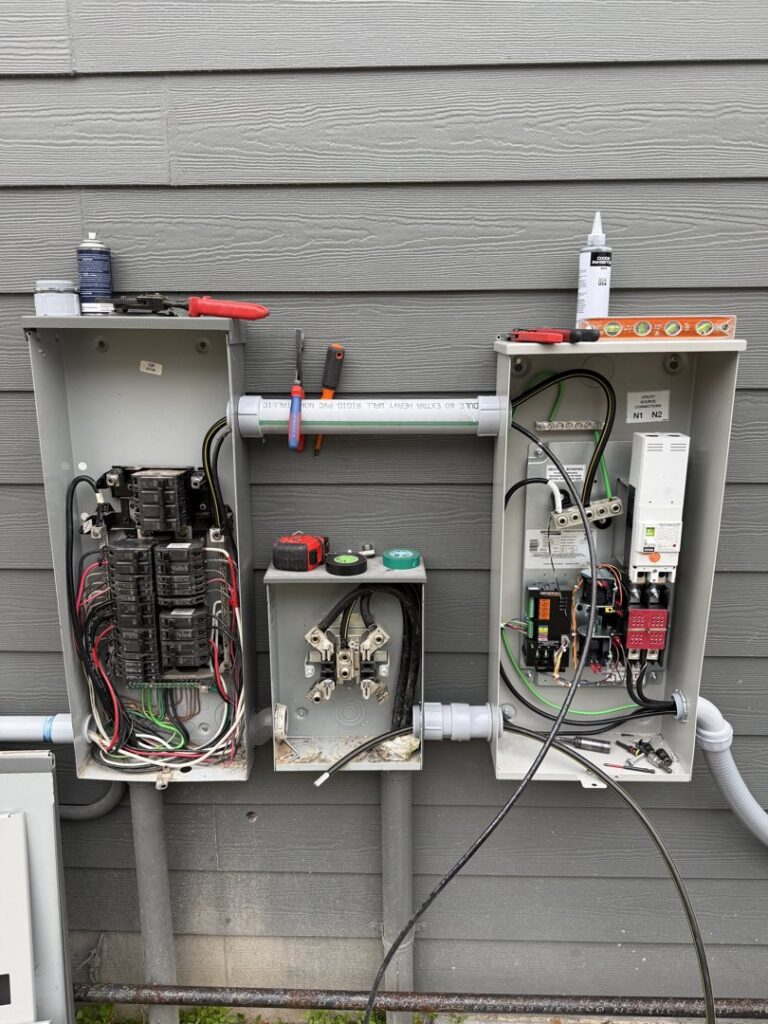 Electrical panel and generator transfer switch installation with tools by Ark Electrical Service in Tomball, TX