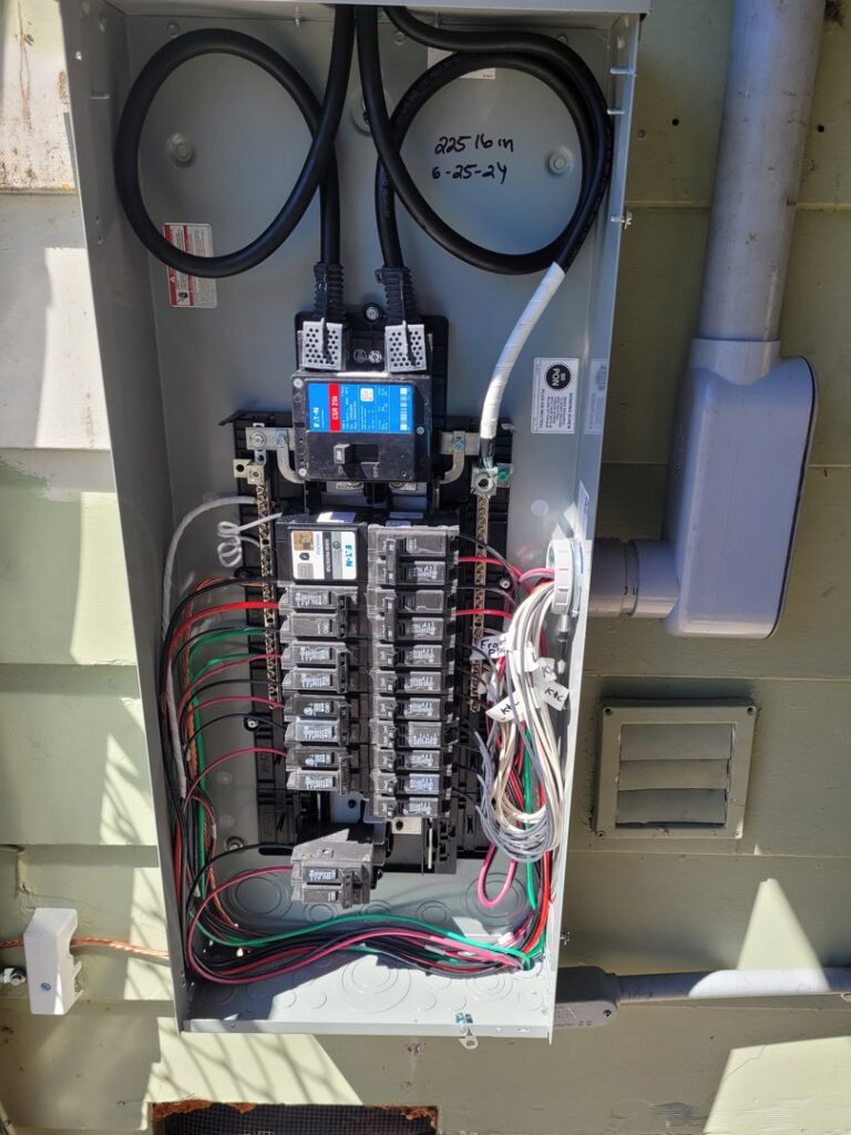 An open electrical panel with new wiring and circuit breakers installed by Ant Power Electric in Tacoma, WA.