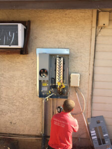An electrician from Farris Electric LLC performing an electrical panel upgrade in Glendale, AZ.