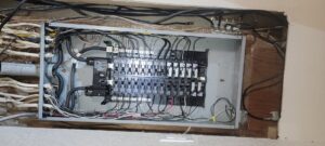 An open electrical panel with circuit breakers and wiring, showcasing professional electrical service by PowerOn Electric llc in Solon, OH.
