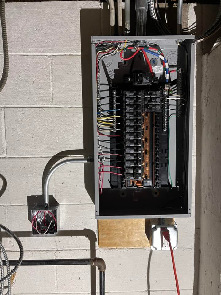 An open electrical panel showing new wiring and circuit breakers, indicating an upgrade or repair by Vera Electric in Aurora, IL.