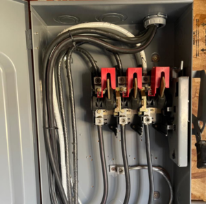 An open electrical panel showing intricate wiring and circuit breakers, expertly installed by AMG Electric LLC Laramie, WY.