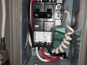 Close-up of an electrical panel with wiring and circuit breakers, showcasing work by Decatur Electrician Now in Decatur, AL.