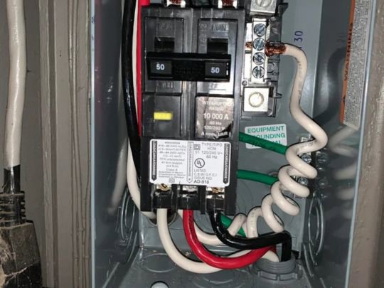 Close-up of an electrical panel with wiring and circuit breakers, showcasing work by Decatur Electrician Now in Decatur, AL.