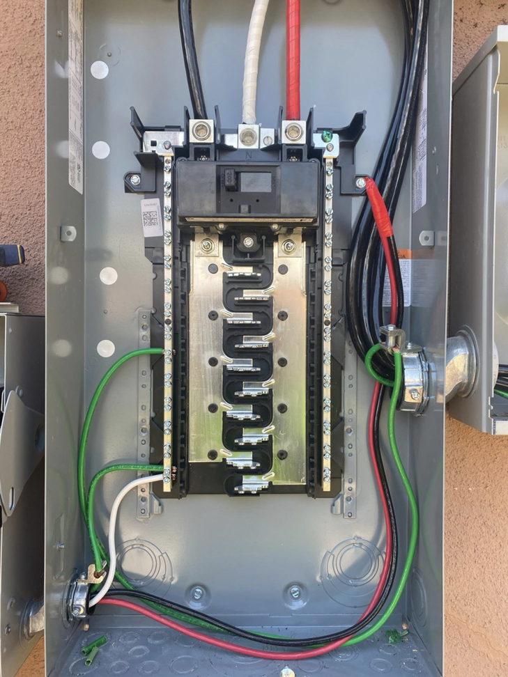 An open electrical panel with wiring and circuit breakers, installed by Flores power solutions in El Paso, TX.