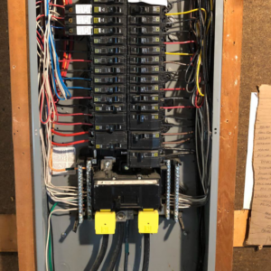 An open electrical panel showing circuit breakers and wiring, serviced by Gen Pump & Power in Aurora, IL.