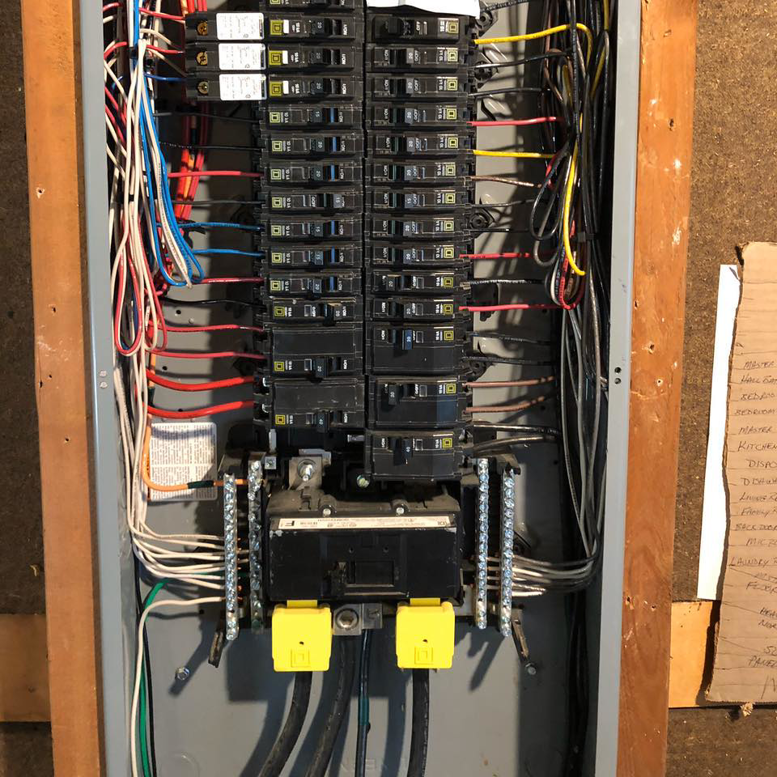 An open electrical panel showing circuit breakers and wiring, serviced by Gen Pump & Power in Aurora, IL.