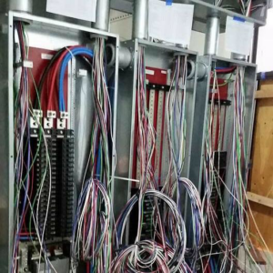 An electrical panel with complex wiring and conduits being installed by Azure Electrical in Indianapolis, IN