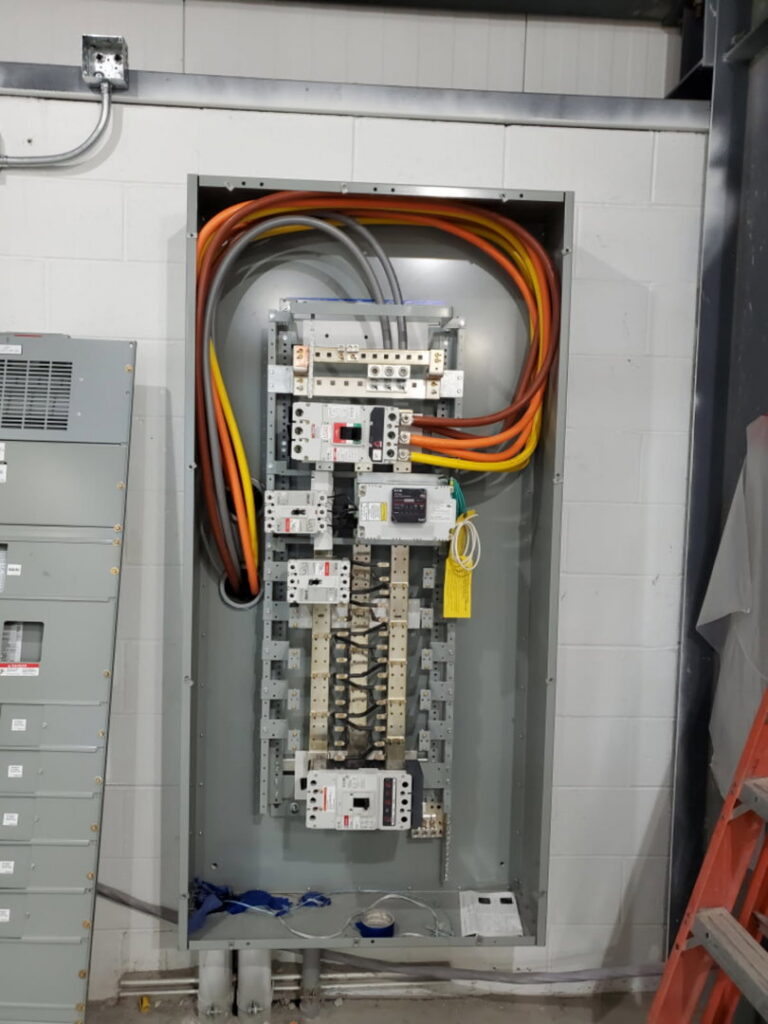 Detailed view of an electrical panel with heavy-gauge wiring and circuit breakers installed by Bottom To The Top Electric LLC in Lakewood, CO.