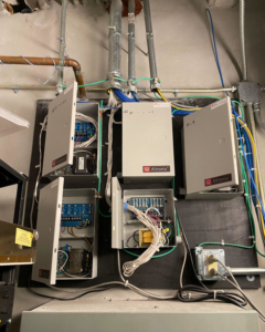 Detailed view of electrical panel wiring and conduit installation by Canseco Electrical Contractors, Inc. in Miami, FL.