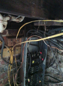 An electrical panel with exposed wiring, showcasing an installation by Elemental Electrical in Chattanooga, TN.