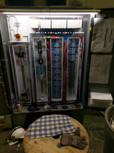 An open electrical panel showing complex wiring and circuit boards, installed by Frontline Electric in Pocatello, ID.