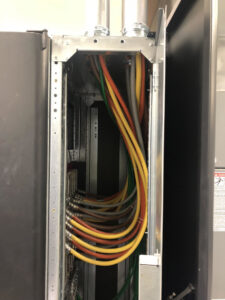 Interior of an electrical panel showing neatly routed colored wires, installed by Harbour Electric in Wilmington, NC.