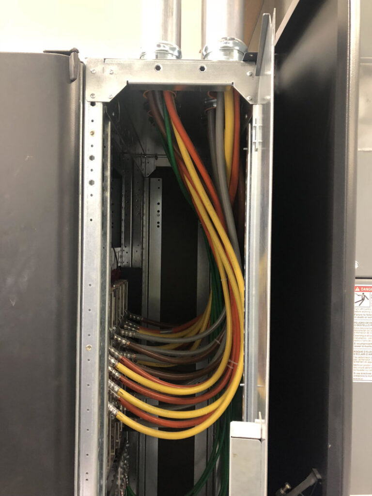 Interior of an electrical panel showing neatly routed colored wires, installed by Harbour Electric in Wilmington, NC.