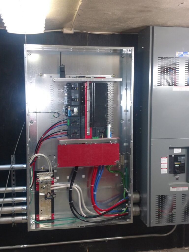 An open electrical panel showing circuit breakers and organized wiring installed by Icon West Corporation Electrical Contractors in Springfield, MA.