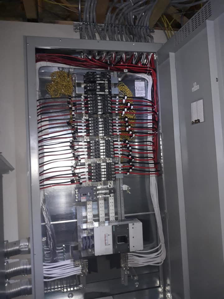 An open electrical panel showing complex wiring and circuit breakers, installed by Jimenez Electric Inc in Denver, CO.