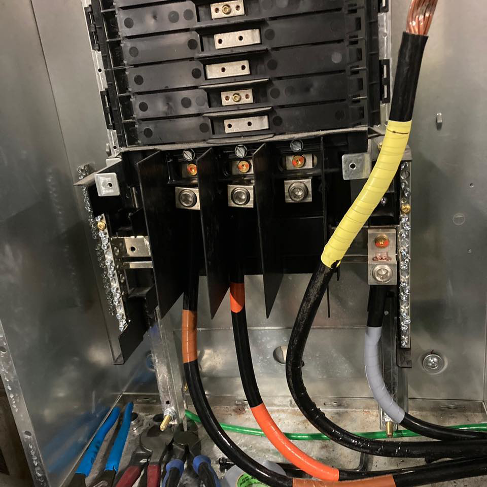 An electrician installing new wiring in an electrical panel for Prolific Resurrection LLC in New Orleans, LA.