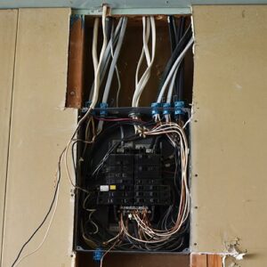 Electrical panel with visible wiring and circuit breakers during installation by True Light Electric in Albuquerque, NM.