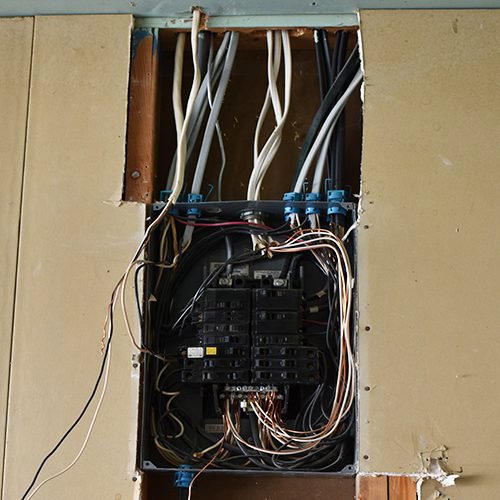 Electrical panel with visible wiring and circuit breakers during installation by True Light Electric in Albuquerque, NM.