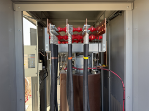An open electrical panel showing heavy-duty wiring and busbar connections, demonstrating electrician work by WES in Houston, TX.