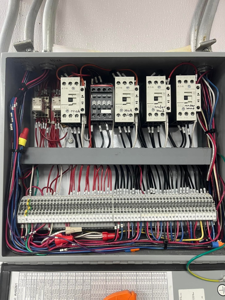 An open electrical panel showing complex wiring and components, serviced by JJRS Electrical, LLC in Colorado Springs, CO.