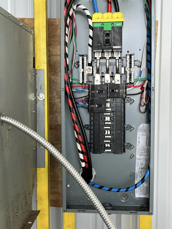 An open electrical panel showing circuit breakers and organized wiring, serviced by K3 Electrical Company Inc in Lafayette, LA.