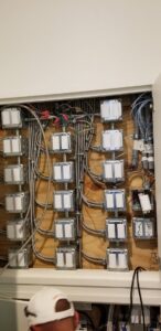 An open electrical panel showing complex wiring and multiple switches, installed by Positricity in Clearwater, FL.