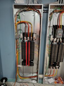 An open electrical panel showing complex wiring and circuit breakers by Pure Light Electric in Kansas City, MO.