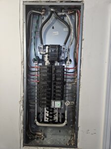 Internal wiring and circuit breakers inside an electrical panel by Crawford Electric Services, LLC in Kings Mountain, NC.