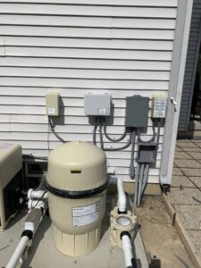 Outdoor electrical panels and wiring installed for a pool pump and filter system by Diamond Electric in Toledo, OH.