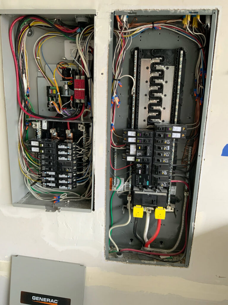 Two open electrical panels with circuit breakers and wiring, installed by Washington Generators LLC in Kent, WA.