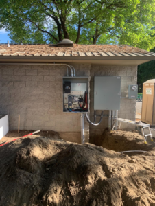 Electrical panels and conduit installed on an exterior wall, showcasing work by Interstate Electrical Contractors in Dalton Gardens, ID.