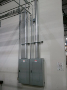 Newly installed electrical panels and conduit on a wall by J.S.S. Electric, Inc. in Cleveland, OH
