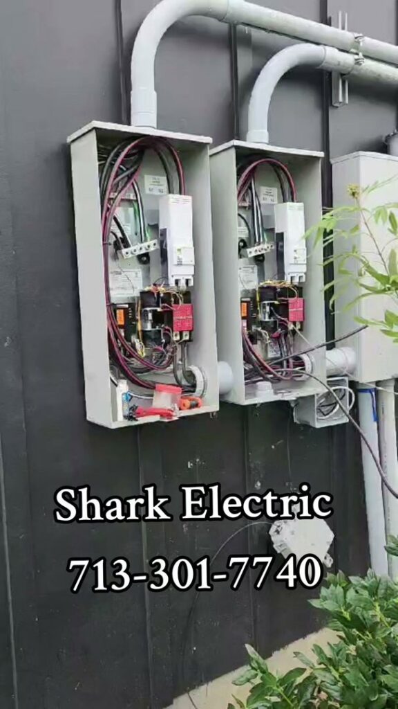 Close-up of electrical panels and wiring installed on a building by Shark Electric in Houston, TX.