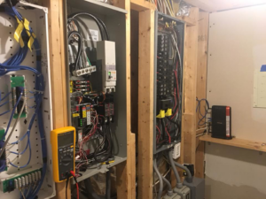 An electrician's multimeter checking complex electrical panels and wiring at a job site for ELSI Electric LLC in Rockville, MD.