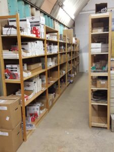 Shelves stocked with various electrical parts and components for generator service at Varitech, Inc. in Louisville, KY.