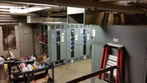 An electrical room with multiple panels and wiring, showcasing installation work by Titan Electric in Bellevue, WA.